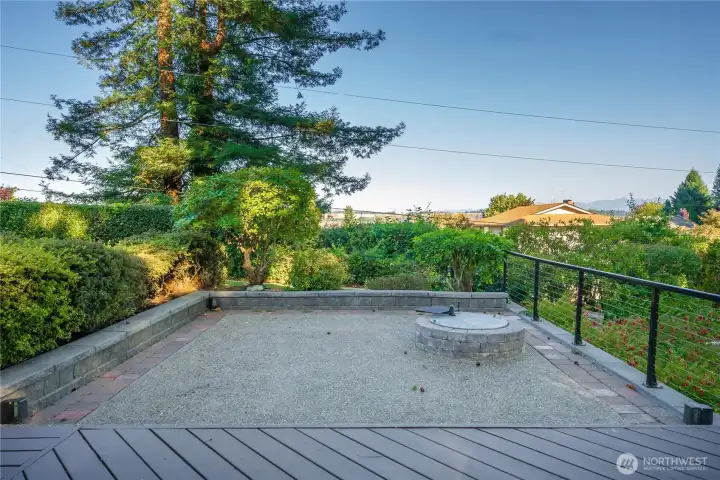 There's a stunning full view of Mount Rainier from here just to the right of this photo. Relax around your firepit or entertain friends, there's plenty of room for everyone here.