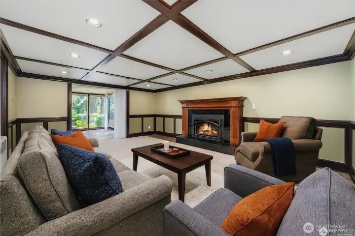 Gorgeous downstairs family room with a cozy gas fireplace. It opens to another room that could be used as a game room, guest space, library, or whatever you wish.