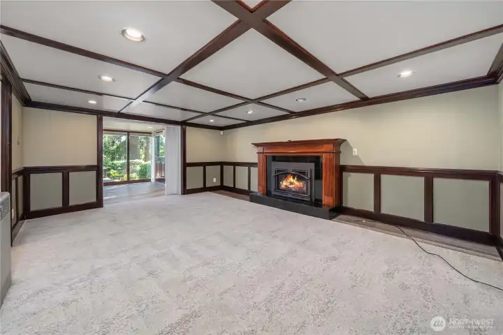 Gorgeous downstairs family room with a cozy gas fireplace. It opens to another room that could be used as a game room, guest space, library, or whatever you wish.