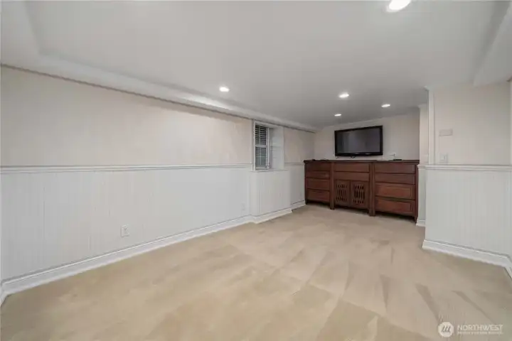 Primary bedroom downstairs with a beautiful built-in dresser set.  The wall-mounted t.v. stays with the house.