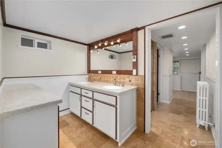 The walk-in closet for the downstairs primary is behind this photo and the amazing steam shower is to the left as you enter the hallway of the primary suite.