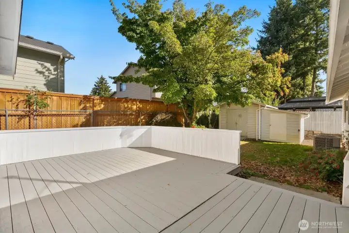 Nestled along back of house is a very private sitting area + back yard.