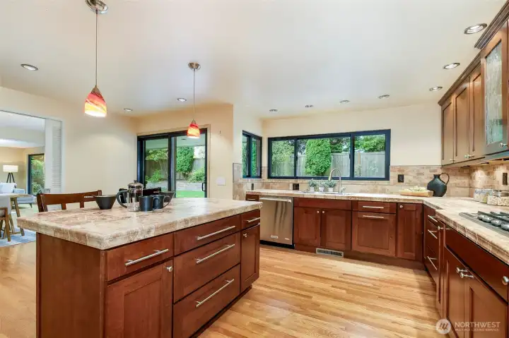 Remodeled gourmet kitchen with large island, gas range, and double ovens in Broadview Seattle home.