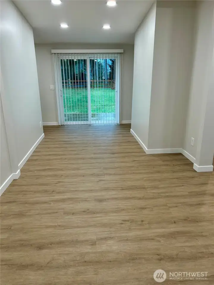 Spacious dining area with new can lighting and a slider, perfect for large family or friend gatherings.