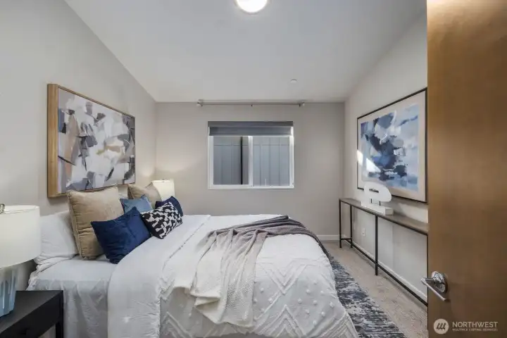 Spacious primary bedroom with vaulted ceilings.