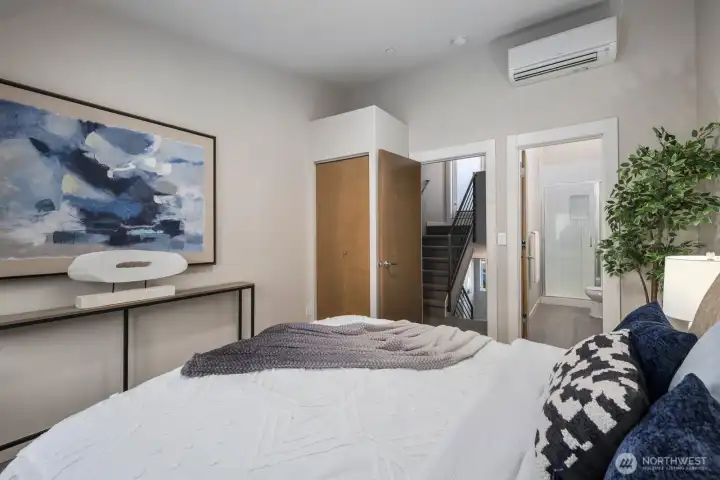 Spacious primary bedroom with vaulted ceilings.