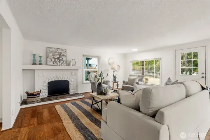 Light filled living room with fireplace.