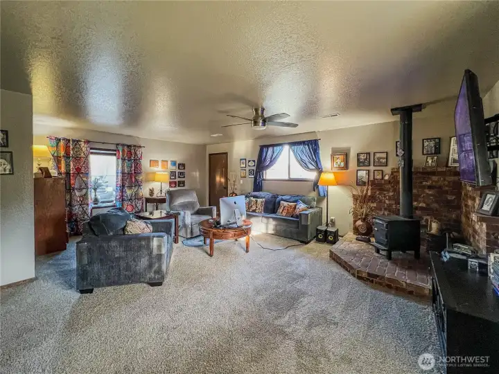 Spacious family room with wood stove, 3/4 bath and access to the side and back yards.