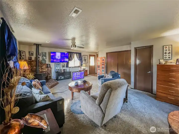 Spacious family room with wood stove, 3/4 bath and access to the side and back yards.