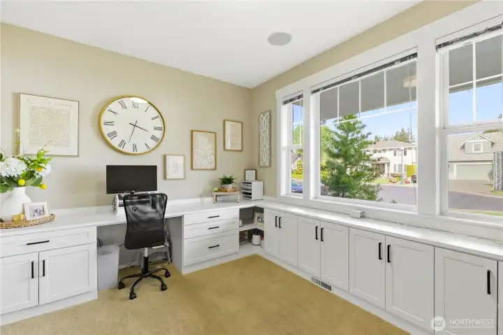 Just off the foyer, a home office offers territorial views, built-in storage, and ample workspace.