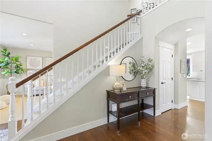 The grand foyer serves as a welcoming central hub of the home.