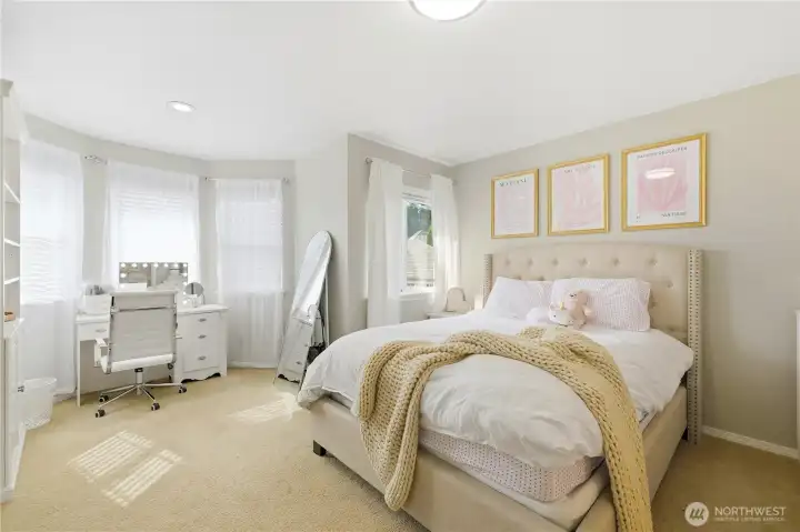 The junior primary suite includes a desk alcove and its own private bath.