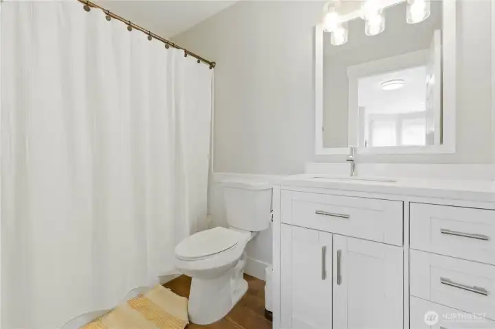 The junior primary full bath features new tile flooring.