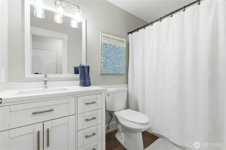 Bedrooms three and four share a tastefully updated hall bath.