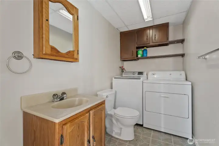 Functional lower level half bath and laundry area.