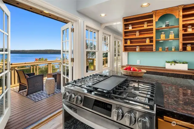 The kitchen features French doors onto the deck and vaulted ceiling.