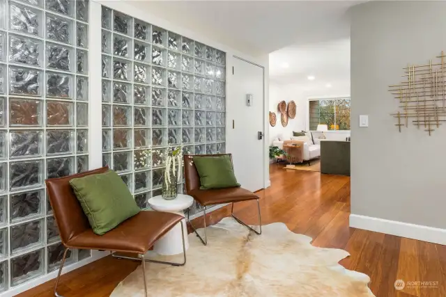 Inviting entryway entryway seating area seamlessly positioned between living room and kitchen.