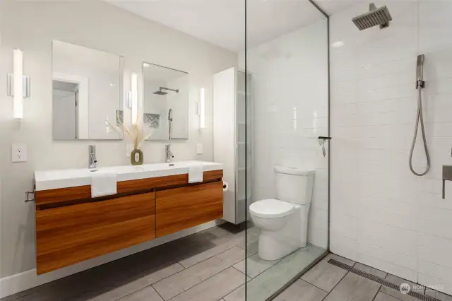 Modern primary bathroom with double sink and heated floors