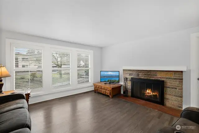 Spacious front living room with cozy wood-burning fireplace