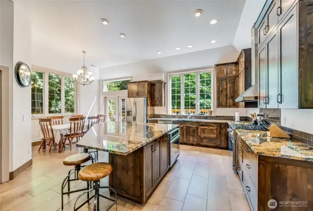 An elegant modern kitchen, with granite tops abounding.  Room to bake, cook and entertain.