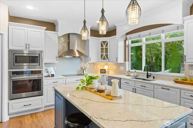 Remodeled chef's kitchen boats quartz counters, new cabinetry, large center island with eating space, SS appliances & wine storage.