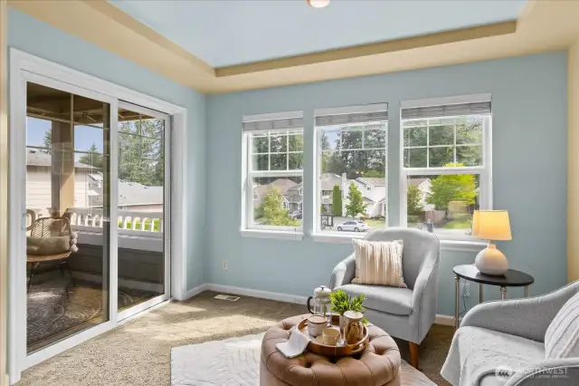 Primary suite sitting area with slider to your private deck.