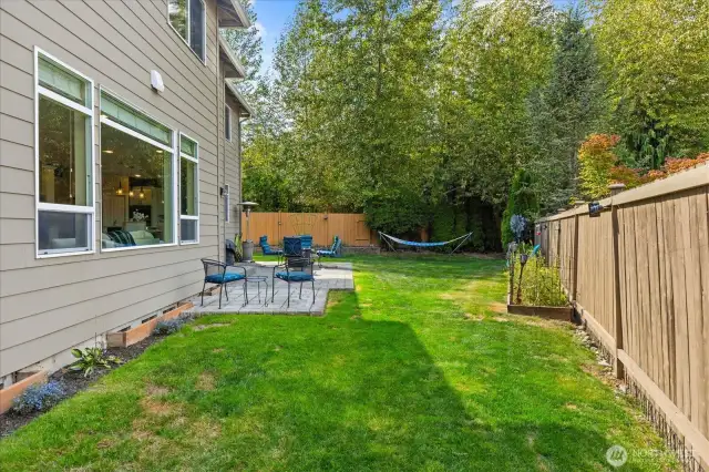 Spacious private back yard adjacent to open space, fully fenced with patio, fire-pit and blueberries!