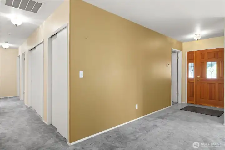 Hallway in living room leading to upstairs bathroom and bedrooms.