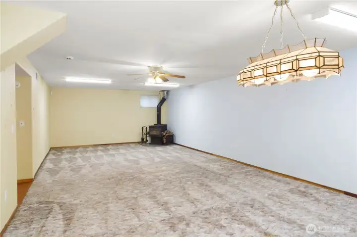 Downstairs living room facing font of home with woodstove.