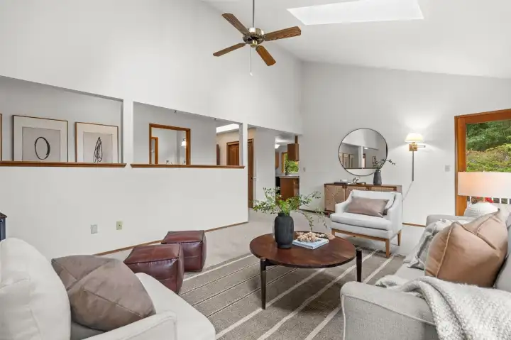 With soaring vaulted ceilings and direct backyard access, the living room combines openness with seamless indoor-outdoor living