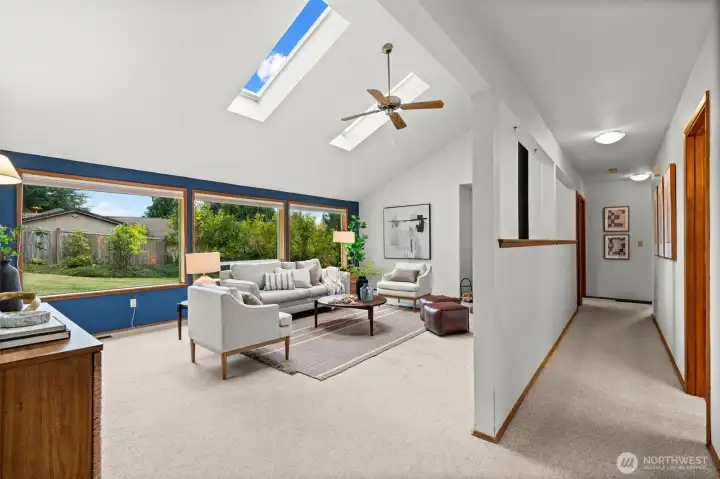 Featuring a half-wall that divides the living room from the wide hallway, this design maintains openness while subtly defining spaces.