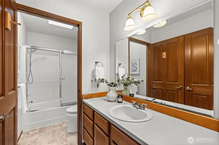 The design separates the bathroom from the vanity area, enhancing both privacy and functionality.