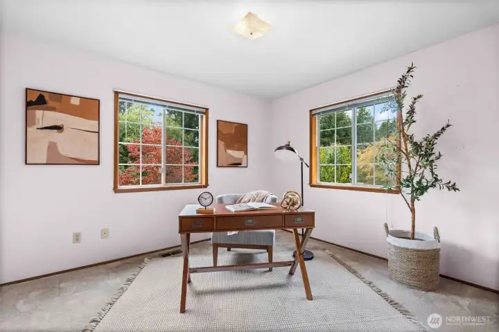 Abundant natural light from both windows enhances the room, making it perfect for work or study.
