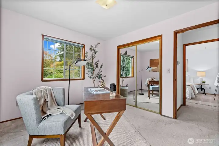 Windows and mirrored closets help open up the space, making the room feel larger and brighter.