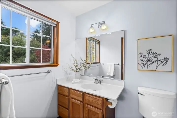 Featuring an open-concept design, this bathroom offers a harmonious layout with the sink, toilet, and shower in alignment.