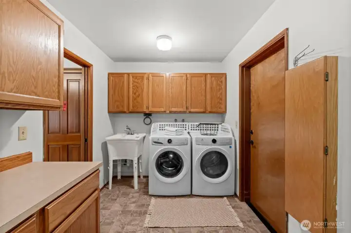 This oversized laundry room provides ample storage and a sink to tackle even the toughest stains.