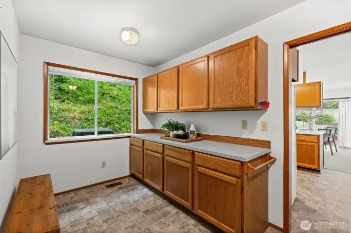 Sunlight streams into the laundry room, creating a bright space where even chores feel refreshing and rewarding.