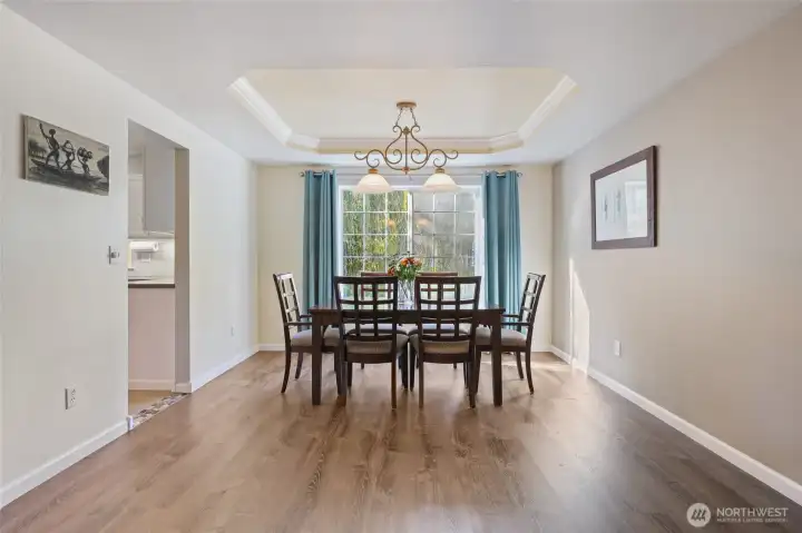 Just adjacent to the living room is a dedicated dining area with trayed ceilings.