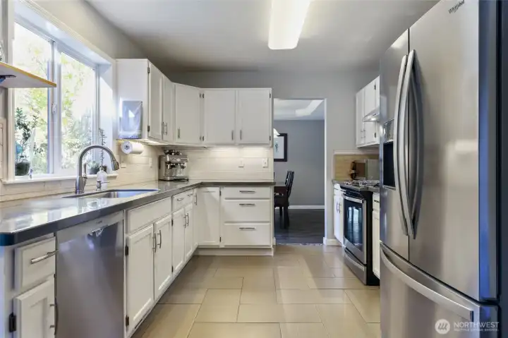 Kitchen has been upgraded. New tile flooring, painted cabinets, appliances, hardware, epoxy countertops, & backsplash.