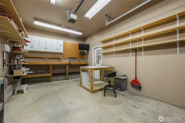 Garage features 3 bays. This 3rd bay was being utilized as a hobby space. Has 2 220V Outlets.