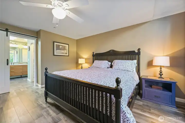 Primary bedroom, sliding barn door leads to custom updated 4 piece primary bath.