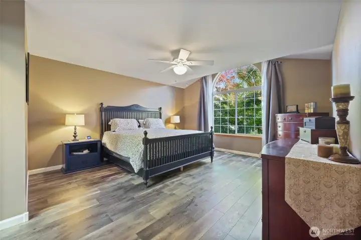 Ceilings in primary bedroom are partially vaulted to bring in extra light.