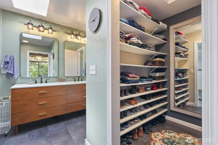 Walk in closet, shelfs on one side and hanging space on the other.