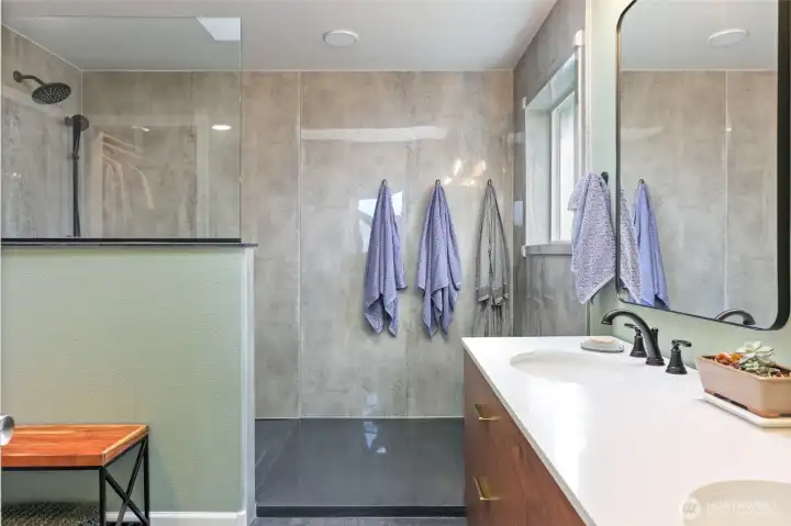 Look at the size of this shower! Lots of natural light with a window at one end. Shower has durabath slab for walls (acrylic material), beautiful and easy to maintain. Just say yes to minimal grout lines!