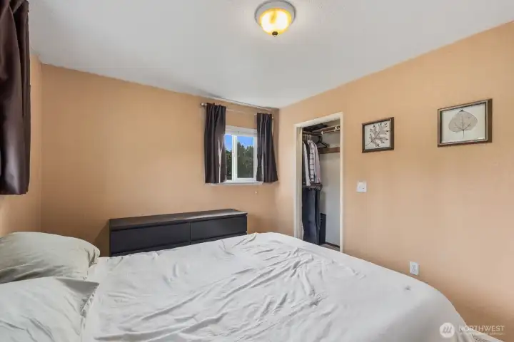 Spacious primary bedroom with reach-in closet and ample wall space for furnishings