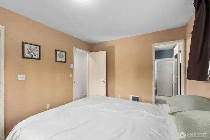 Primary bedroom with direct access to attached bathroom and hallway entry