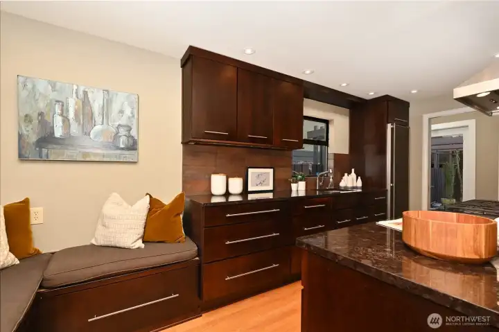 High-end stainless-steel appliances with Euro fridge with designer bench seating.