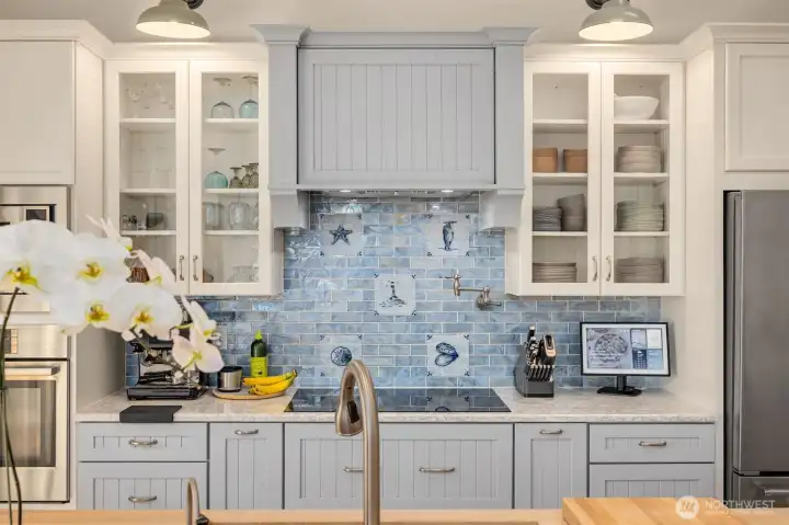 The gourmet kitchen has been fully remodeled with a coastal design, stainless appliances and additional storage,