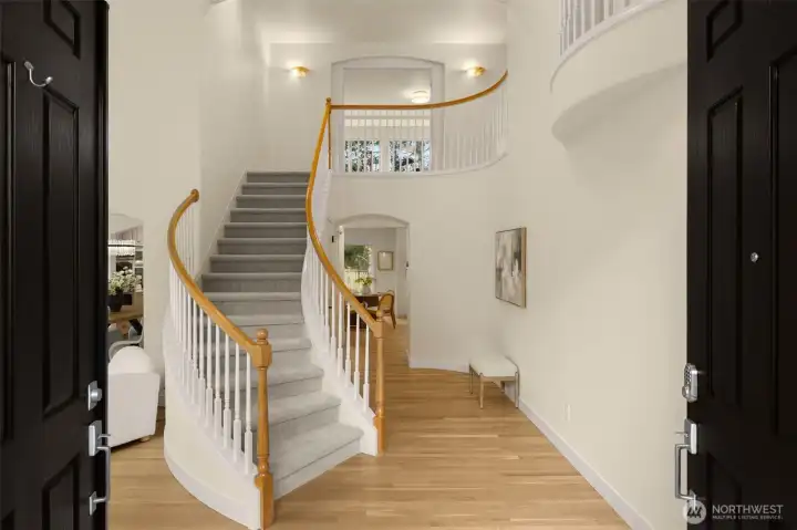 Grand entry with curved staircase.