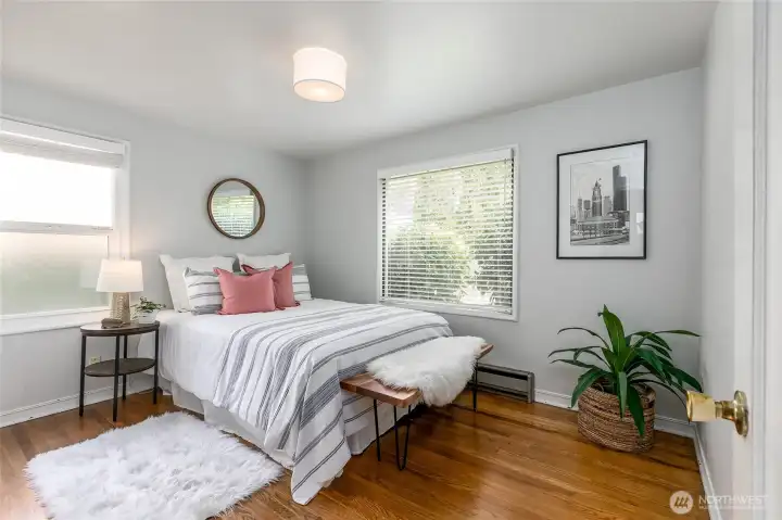 The two additional bedrooms are similar size...... making options for the primary.  The hardwood floors extend to these rooms and the hallway.... Again... lots of windows offer lots of natural light